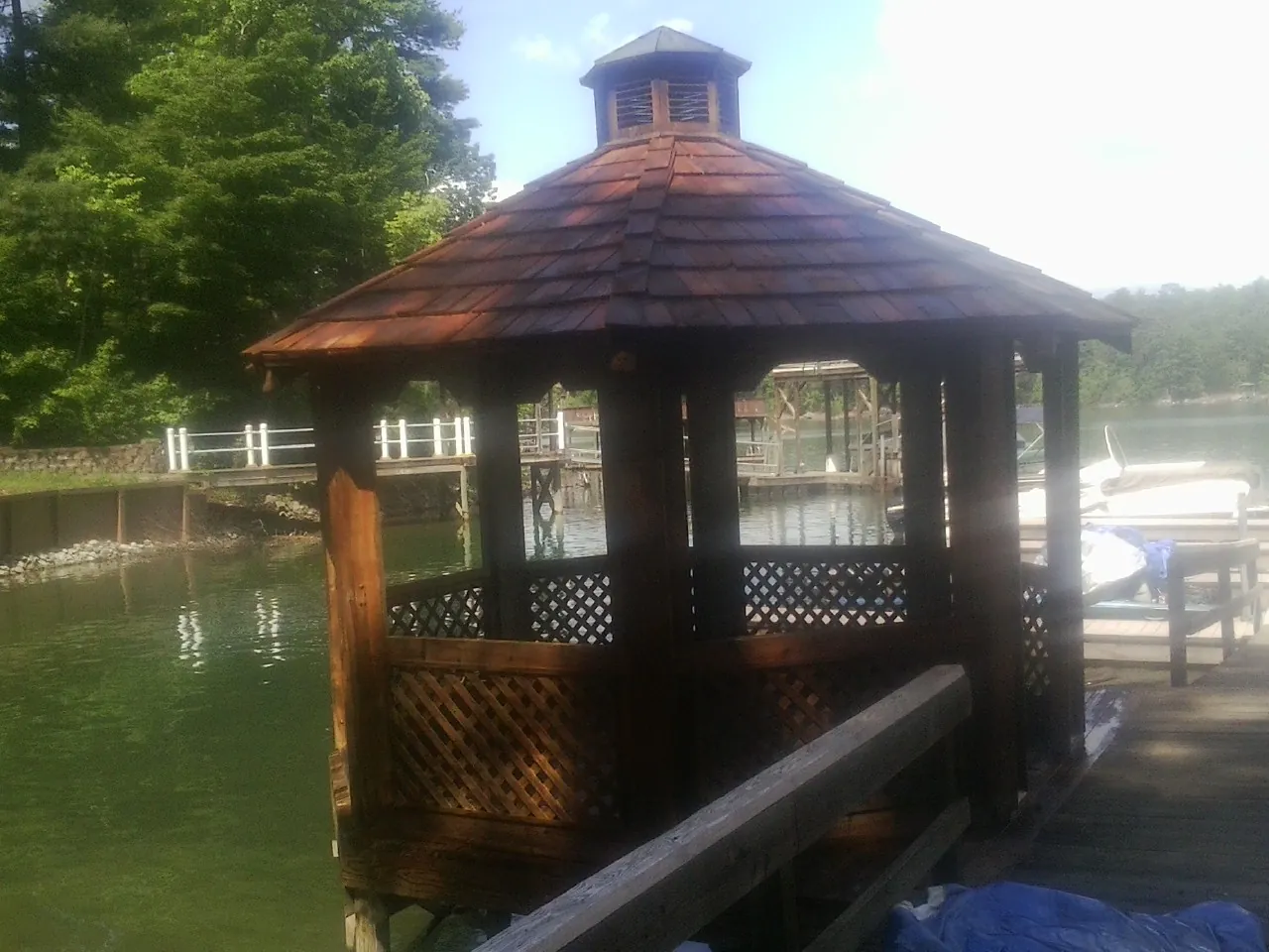 Cedar shake gazebo roof rebuilt on a lake dock in Pine Beach