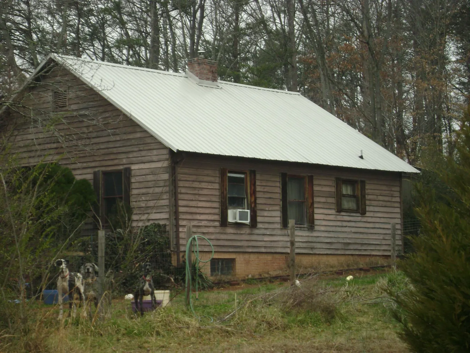 White metal roof on an old wood sided farmhouse, from a Metal Roof Installation job in Pine Beach